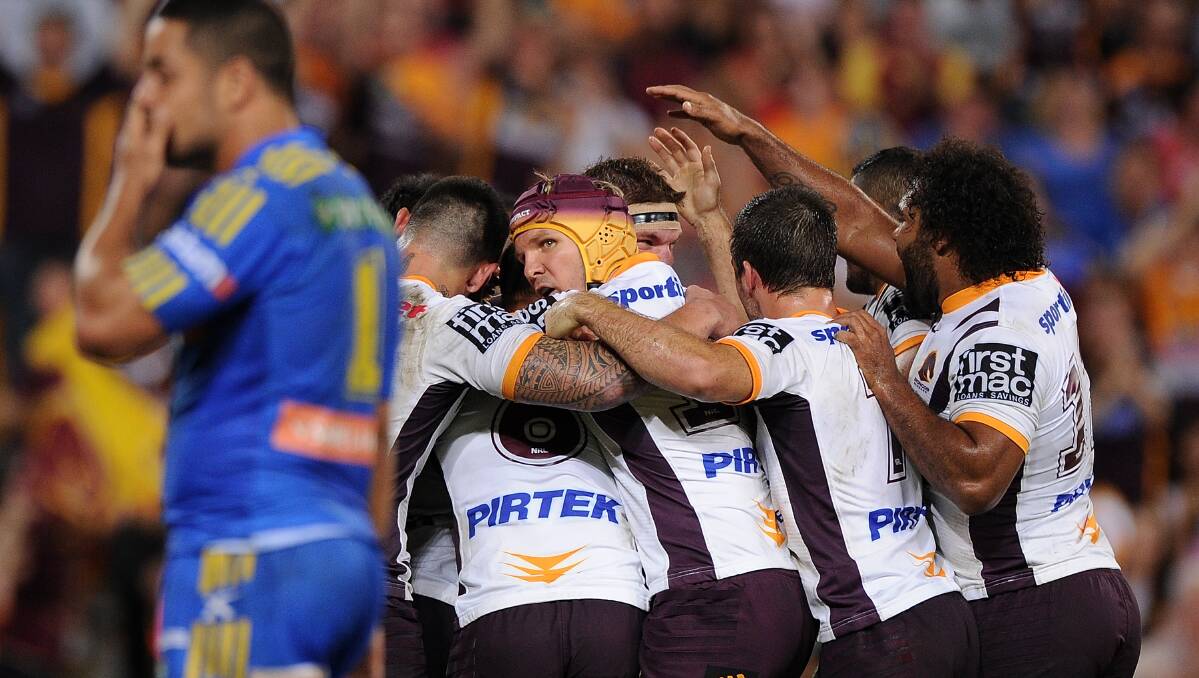 Broncos players celebrate a try by Josh Maguire . The Eels defeated the Broncos 25-18 on Brisbane turf in Round Five of the NRL. Picture: Getty Images