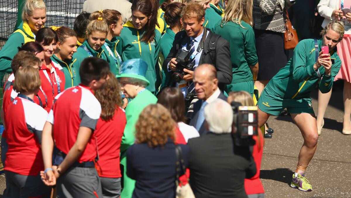 CELEBRITY SIGHTING: Orange's Edwina Bone (right) takes a snap of her Hockeyroos teammates meeting the Queen after they won their first Commonwealth Games match against Malaysia on Thursday (AEST). Photo: GETTY IMAGES