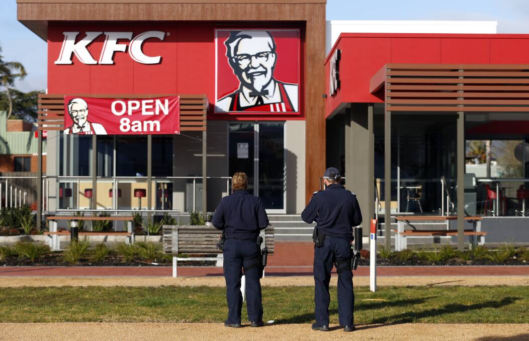 INVESTIGATION: Police outside the KFC building in Elgin Boulevard on Wednesday. Officers joined the SES in a search of the nearby area following an armed robbery on Sunday night. Picture: MARK JESSER