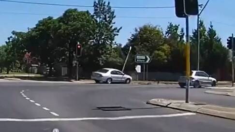 IMPACT: A silver Ford Falcon hits the traffic light on Thursday.