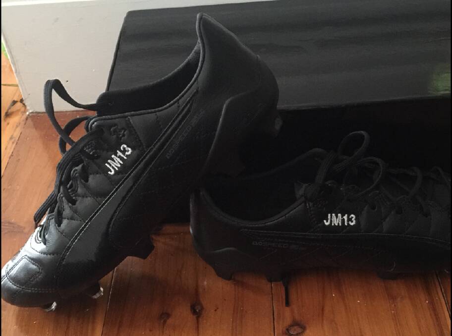 TRIBUTE: Ms McLennan's fiance, Jarryd, has had her initials and netball number stitched into his football boots. 