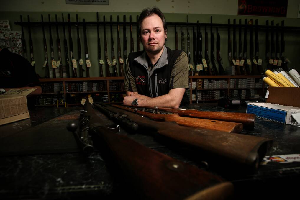 POSITIVE: Elk's Hunting and Fishing manger Justin Elkington with guns surrendered in the amnesty. Mr Elkington says it gives people a chance to hand in or register firearms without fear of penalties. Picture: JAMES WILTSHIRE