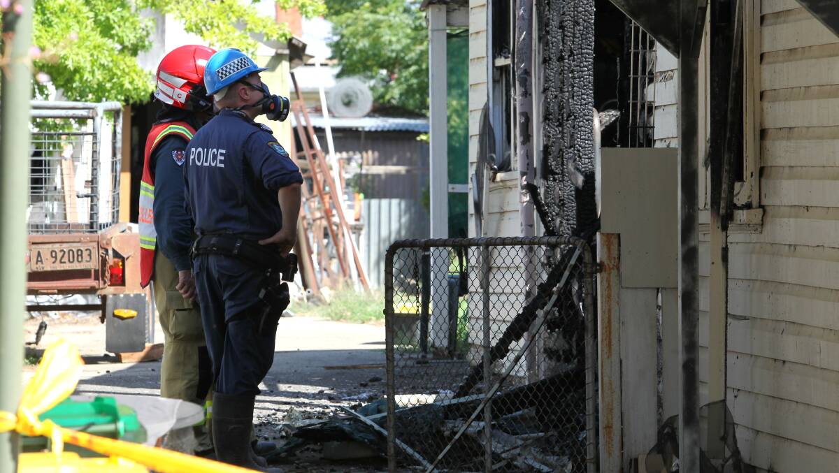 EXAMINATION: Investigators look at damage to the Corowa home. Pictures: BLAIR THOMSON