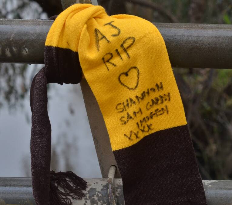 RIP: A Hawthorn scarf tied to bridge railing near the scene of the crash off Stock Route in memory of Mr Crowhurst. 