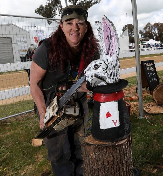 ART: Sculptor and power carver Angie Polglaze with one of her colourful animal creations. 