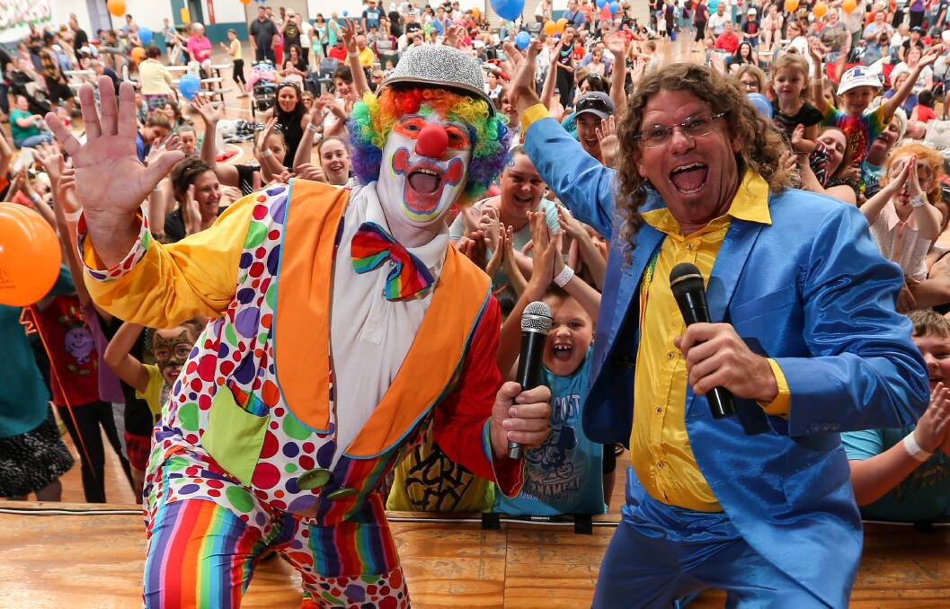 SMILES: Sparky the Clown and Steve Bowen entertain the crowd in Wodonga on Saturday. Organisers say about 2500 people attended the festivities at the Wodonga Sports and Leisure Centre. Pictures: JAMES WILTSHIRE