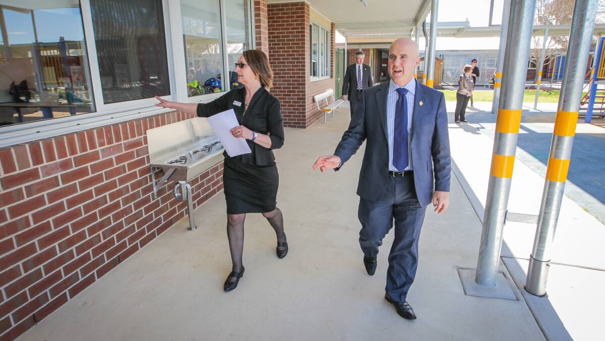 GONESKI: Former Education Minister Adrian Piccoli at Albury's Wewak Street School with principal Linda Cain in 2014. He has lost his portfolio in a reshuffle. 