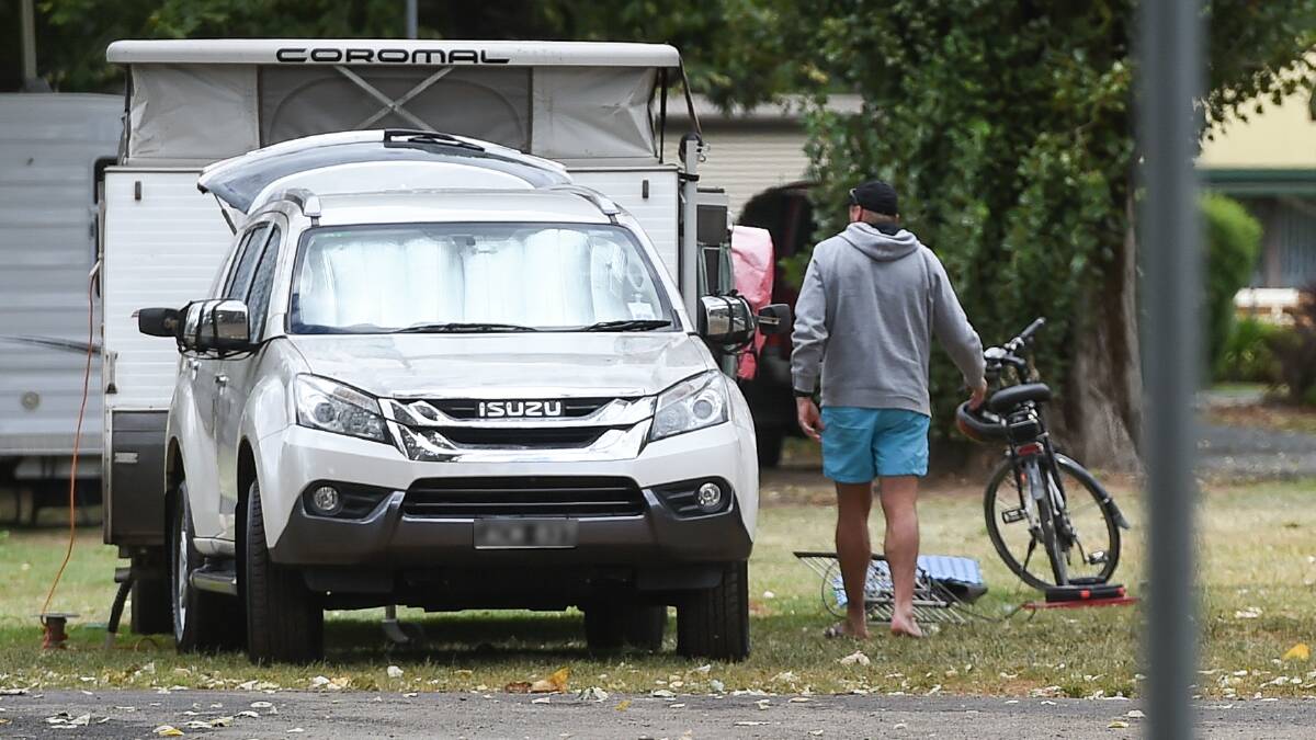 WEEKEND AWAY: The man had been staying in a caravan at the Myrtleford Holiday Park. Police dusted for fingerprints in the van and on the car.