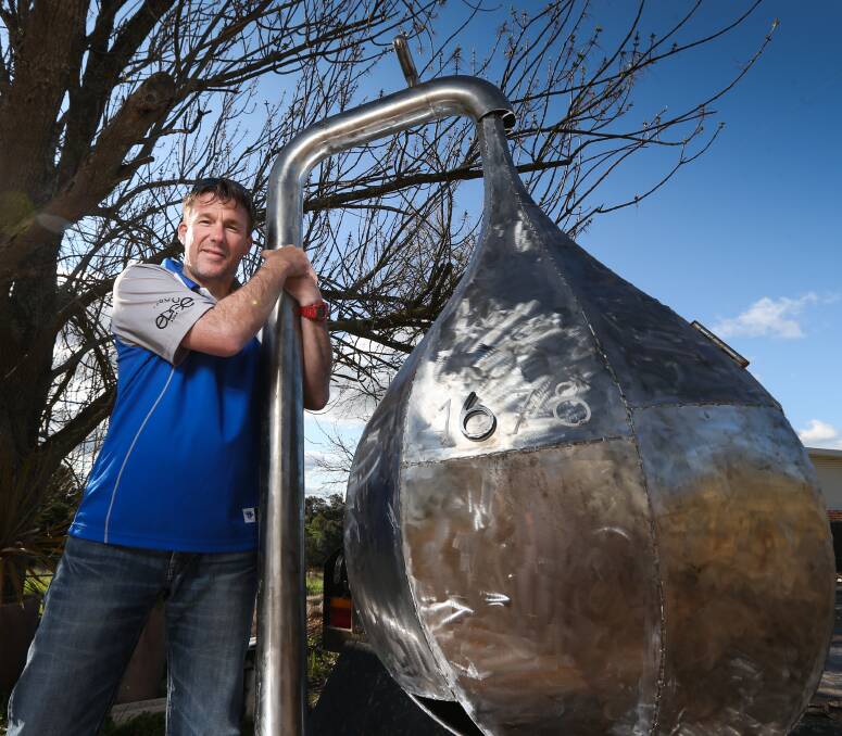 RETURNED: Dave McAuliffe reunited with his letterbox. The unique creation was found largely undamaged despite being stolen and dumped about 25 kilometres away by the thieves. Picture: JAMES WILTSHIRE