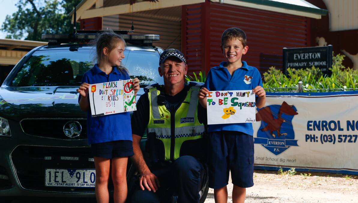 POSITIVE: Sergeant Michael Connors says handing out drawings with fines is making things safer for Everton Primary School students like Ascha Comey-Harvey and Ashton Boyd. 