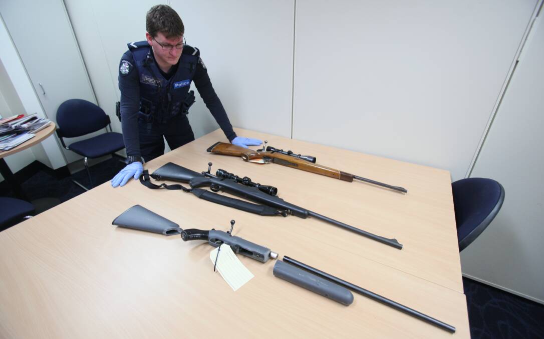 RECOVERED: Wodonga Constable Brendon Gordon with three stolen rifles in September. 
