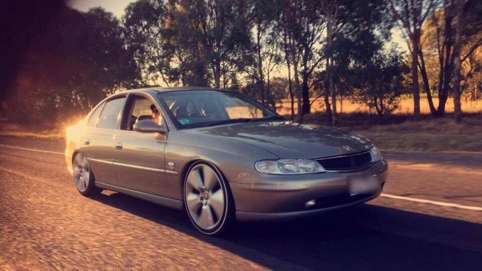 CHARGED: Dylan Leitch, pictured driving his Holden Commodore Calais, has lost his licence for two years after being filmed performing burnouts in the car. 