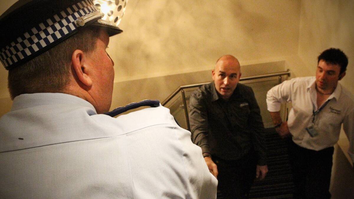 COMPLY: Venue manager Brendon Cooper, pictured in a staircase with police in 2011. Mr Cooper said he was fully complying with officers. 