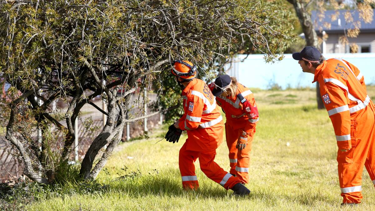 SEARCH: SES members scour the area near KFC the morning after the incident. 