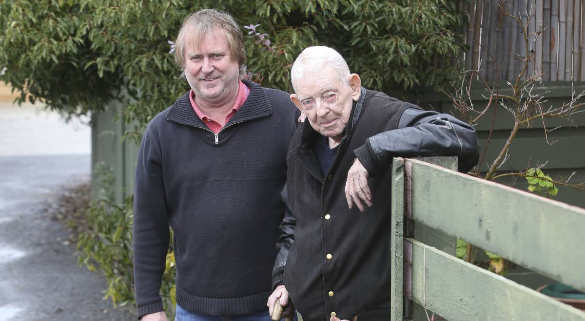 SUPPORT: Mark Young with Frank Bensted outside his home. Mr Young saved the property by using a garden hose. Picture: ELENOR TEDENBORG