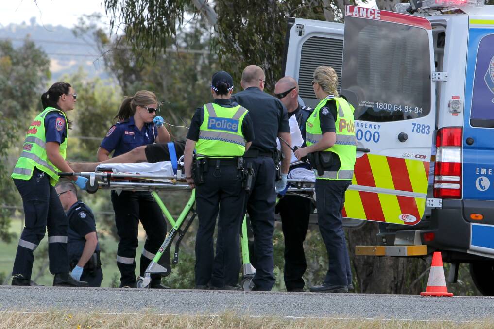 HOSPITALISED:  The truck driver is placed in an ambulance before being taken to Wodonga Hospital. Picture: BLAIR THOMSON