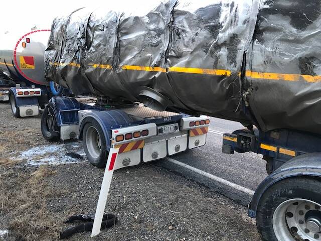 DAMAGED: The tanker tipped over and caused thousands of litres of milk to spill out onto the side of the Murray Valley Highway on Thursday morning. 