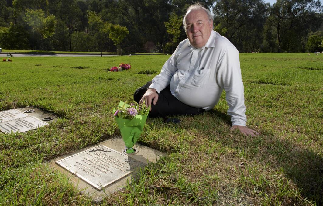 STILL GRIEVING: Wayne Beer at his father's grave at the Albury Lawn Cemetery. He hopes a million dollar reward will help solve the 23-year-old cold case. 