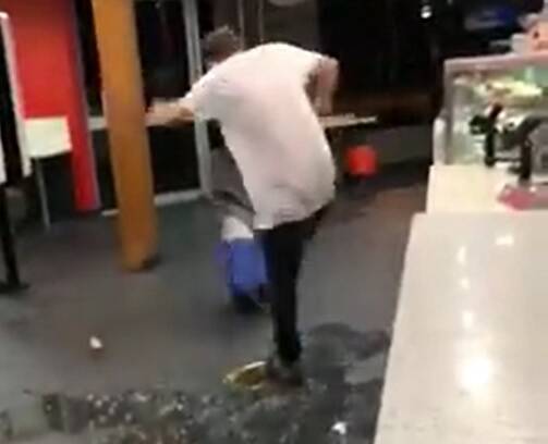 ANGRY: The man kicks around a cooler in the McDonald's restaurant 