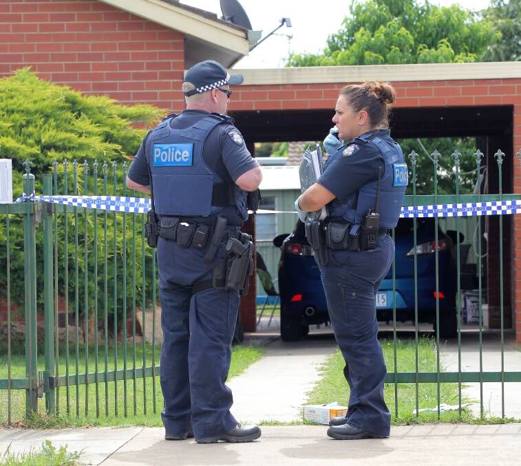 CRIME SCENE: Police guard a home where a body was found on Sunday. Pictures: BLAIR THOMSON