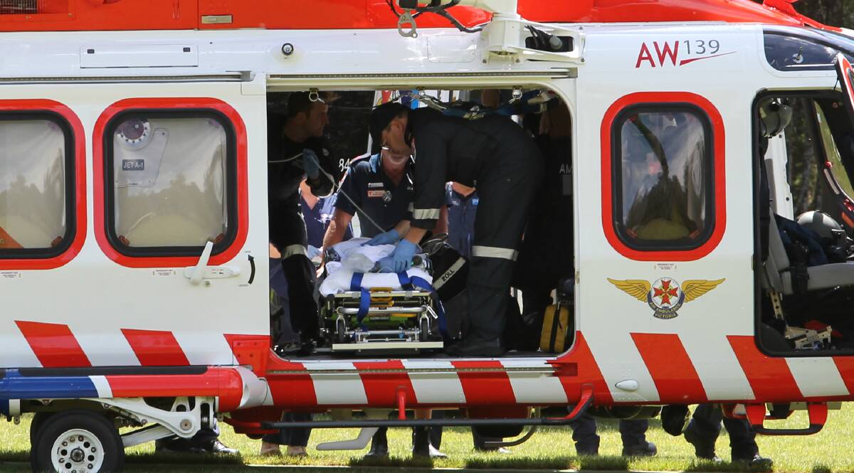 TRANSPORT: Paramedics prepare to airlift the girl to Melbourne. Pictures: BLAIR THOMSON