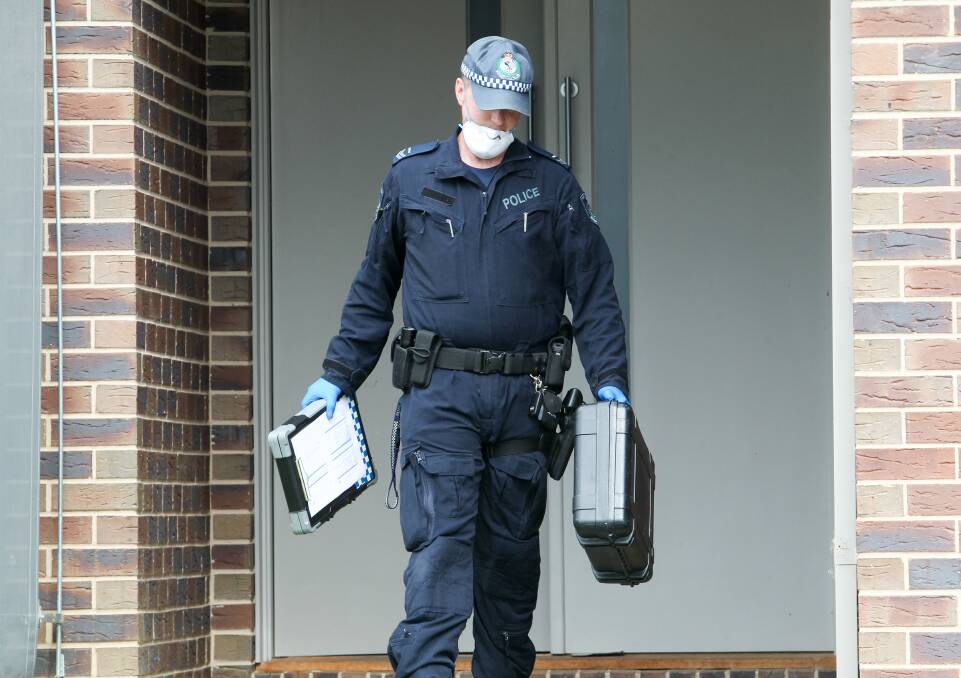 CRIME SCENE: A forensic officer outside a home in Jarrah Court, East Albury, following an aggravated break-in by thieves targeting a vehicle. Pictures: BLAIR THOMSON