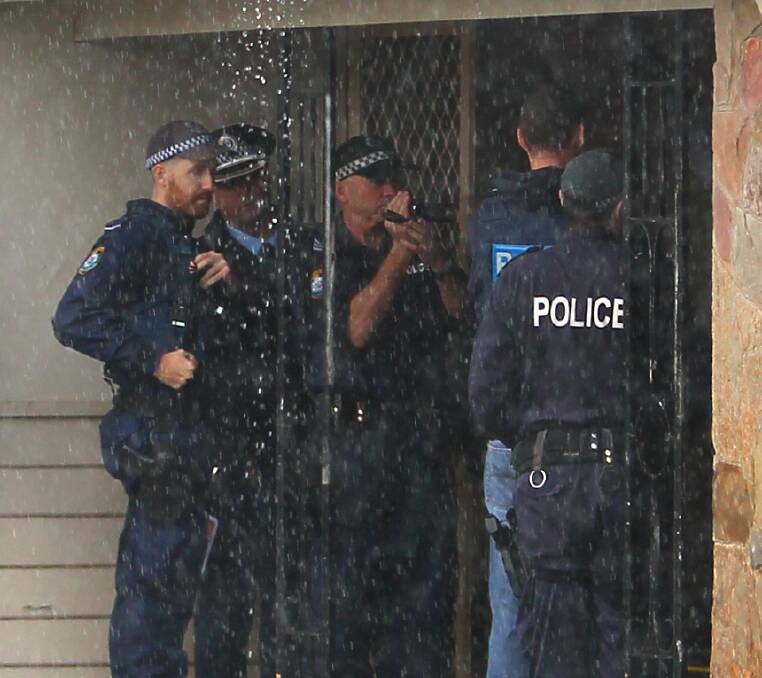 SEARCH: Albury and Wodonga officers outside the property on Thursday morning. Picture: ELLEN EBSARY
