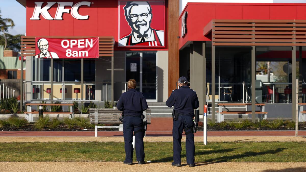 TARGET: Police outside the KFC on Elgin Boulevard the morning after the incident. 