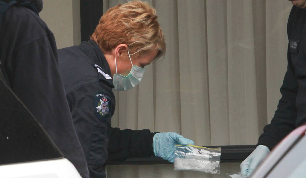 RAID: A bag of ice is removed from the Wodonga hotel room on Friday. Picture: BLAIR THOMSON