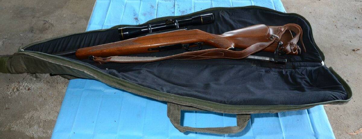 SEARCH: The rifle, pictured with gun bag and brown leather strap. 