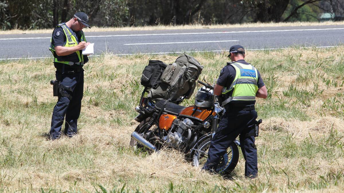 DAMAGE: Police inspect a crashed Honda on Sunday. Picture: BLAIR THOMSON