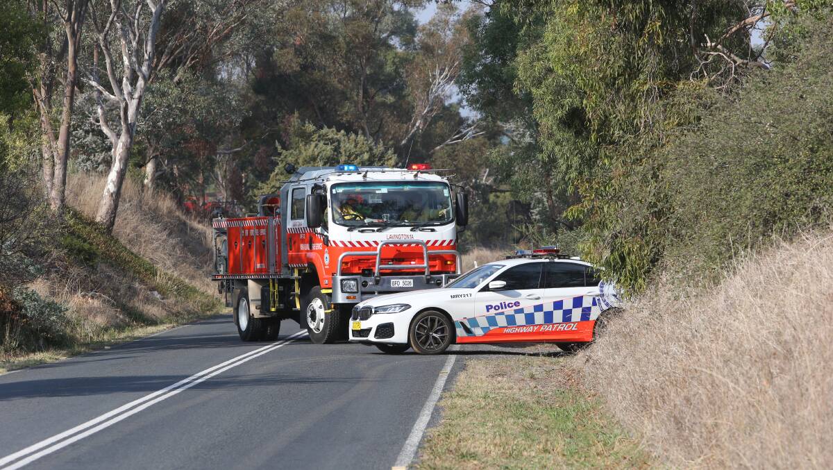 Police and firefighters at the scene of the blaze on Table Top Road at Table Top on Wednesday morning. Picture by Blair Thomson