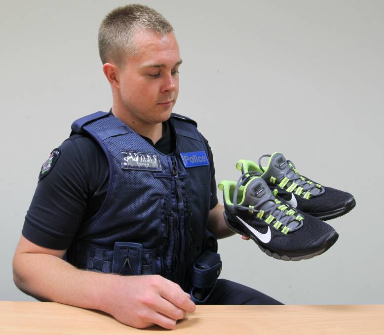 STOLEN: Constable Jake Bradford with a pair of Nike runners which have twice been stolen. Police suggest people keep their shoes inside to avoid them being stolen and ending up for sale on Facebook. Picture: BLAIR THOMSON