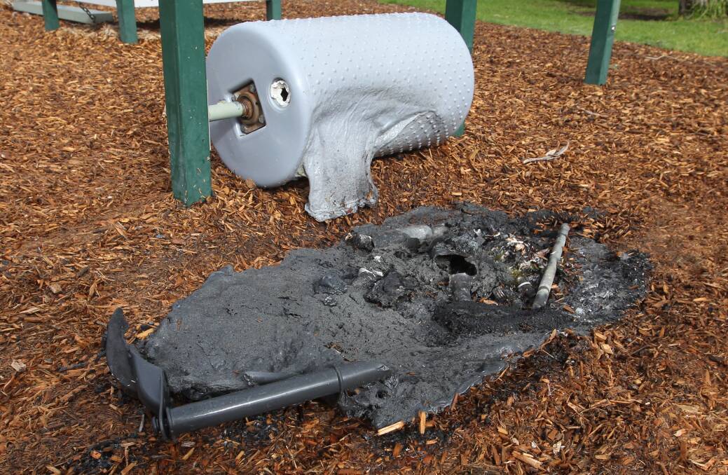 BURNT OUT: A rubbish bin was pushed against play equipment in Sarvaas Park early Tuesday morning before being set alight. Picture: BLAIR THOMSON