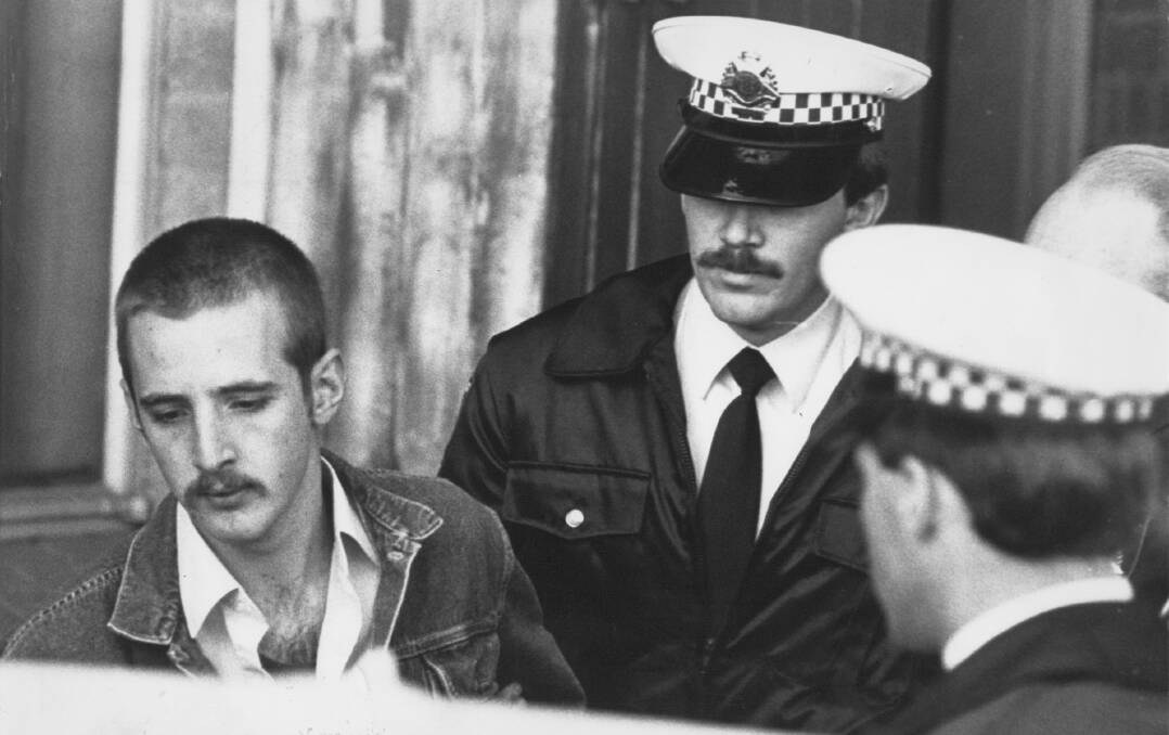 UNDER ARREST: Julian Knight was given seven life sentenced for the Hoddle Street massacre. 