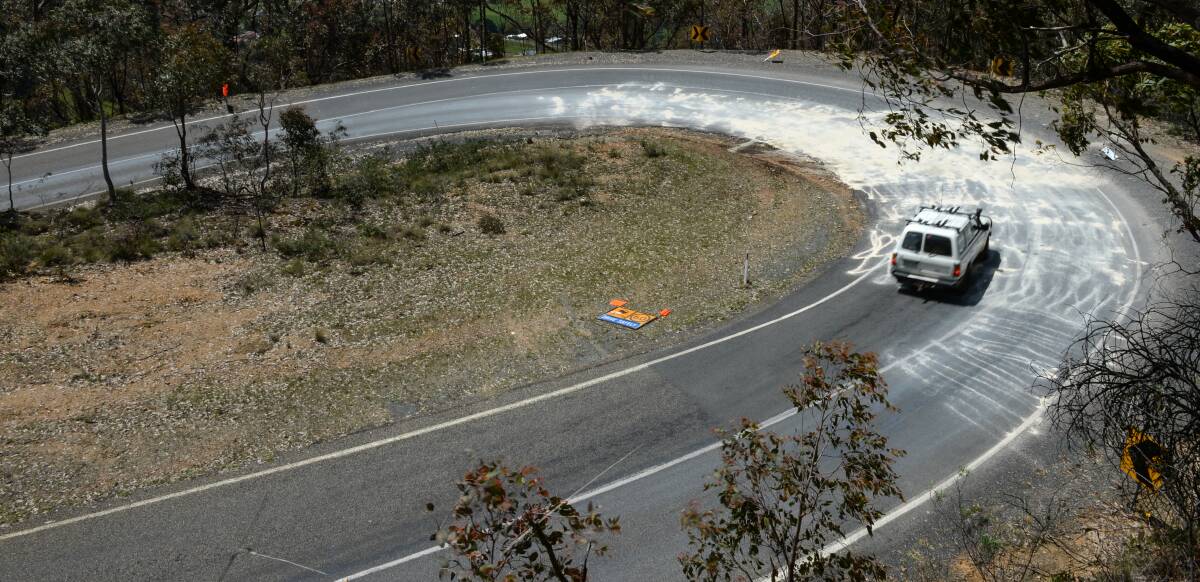 SPILL: A four-wheel-drive travels over the area where the diesel spilled on the Tawonga Gap Road at the weekend after the fuel was soaked up. 