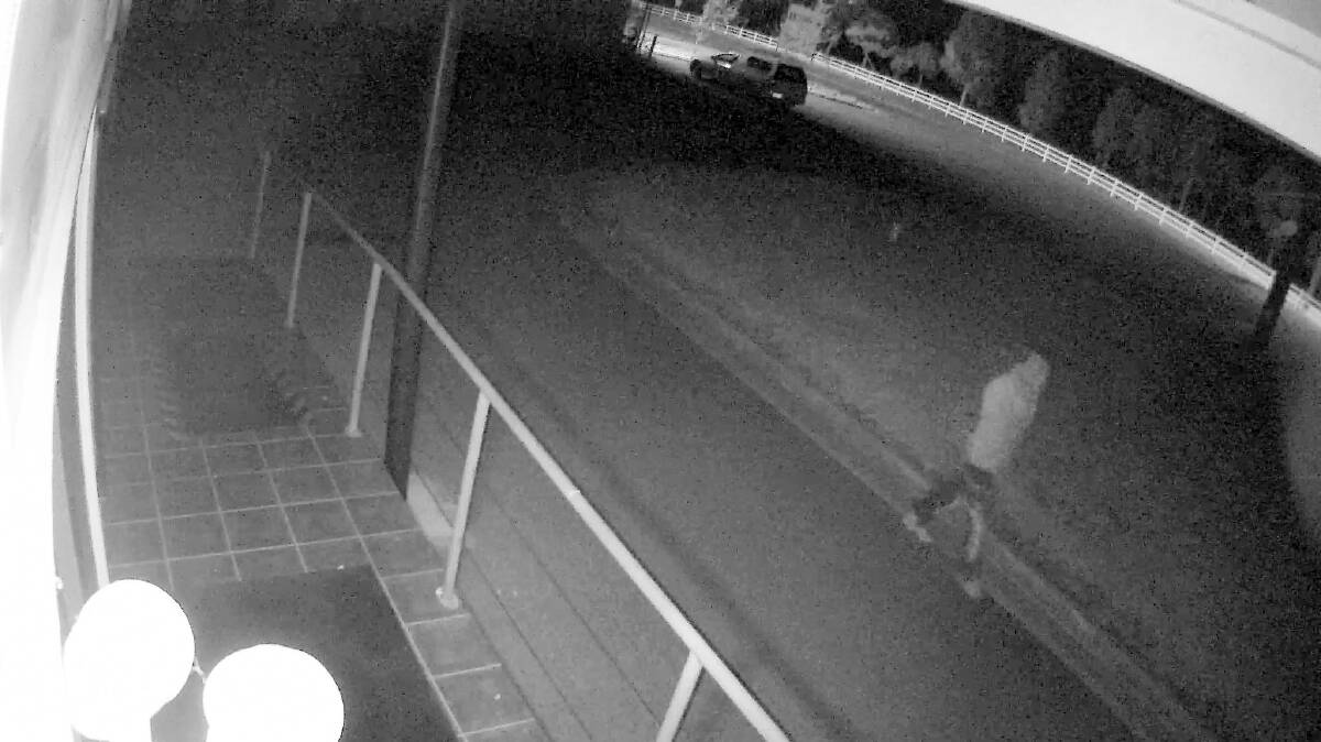 WANTED: The man parked his car, pictured at the top of the image, and walked down into the Wodonga business about 10pm on Tuesday. 