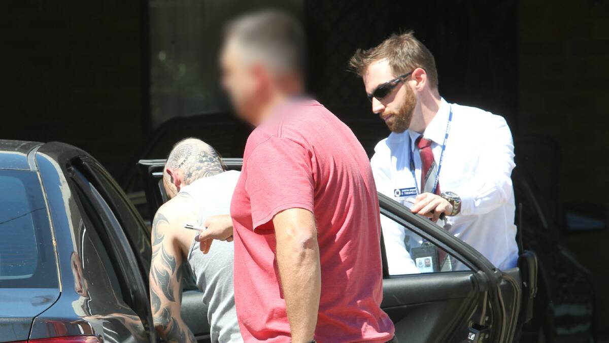 ARRESTED: The resident at the Lavington home is placed into a police vehicle before being taken back to the Albury station. Pictures: BLAIR THOMSON