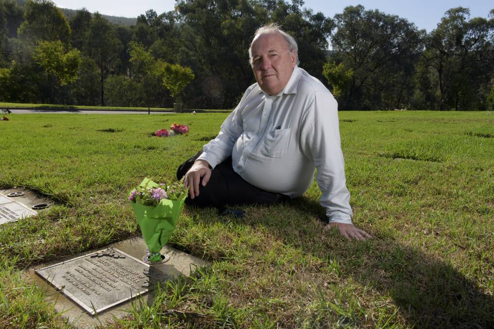 STRUGGLING: Wayne Beer, pictured at his late father's grave in Albury, says he is still saddened by his death more than 23 years on. 