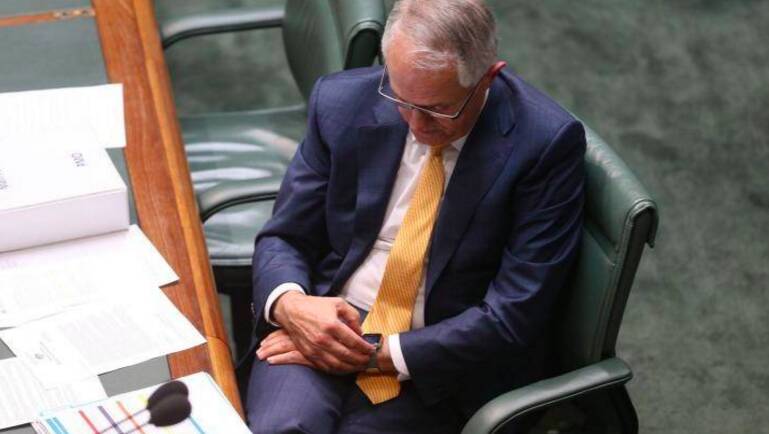 Prime Minister Malcolm Turnbull checks his Apple watch during Question Time at Parliament House. Photo: Andrew Meares