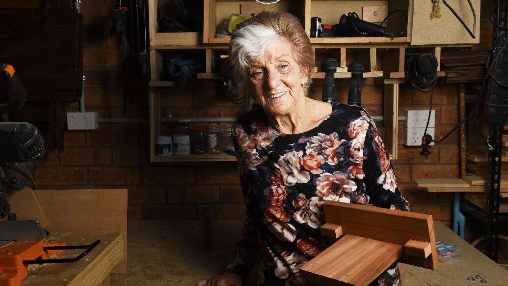CRAFTSMANSHIP: Marg Callaghan in her shed working on her latest project. She is currently filling a three-storey doll house with furniture. Picture: Luka Kauzlaric