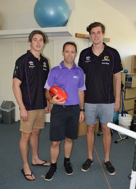 HOPEFUL: Healthfocus Physiotherapy director Michael Bowler (centre) is pictured with two local draft hopefuls Lachlan Tiziani (left) and Mitch King.