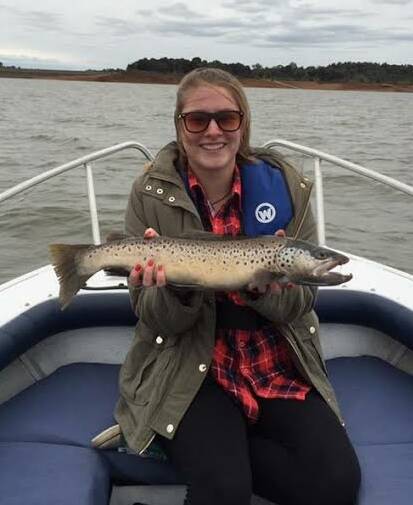 NICE ONE: Dani Sanderson with the lovely trout she caught at Lake Hume. The 62cm catch was caught trolling.