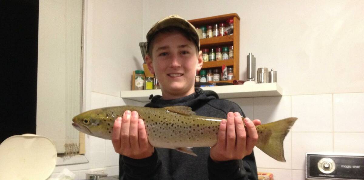 BEAUTY: Ethan Rahaley shows off a nice trout he caught just below the weir wall and judging by the photo, this one ended up on the dinner table.