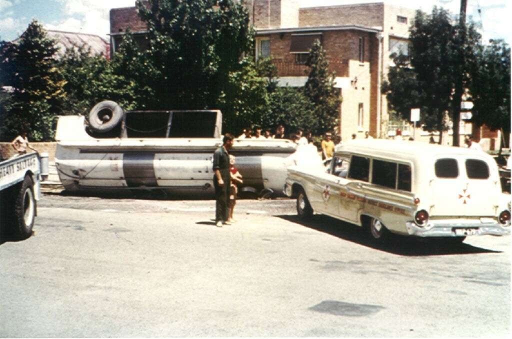 ASSIST: An ambulance attends a milk tanker rollover at the water tower roundabout in the early 1960s. Photo courtesy of Ron Haberfield.