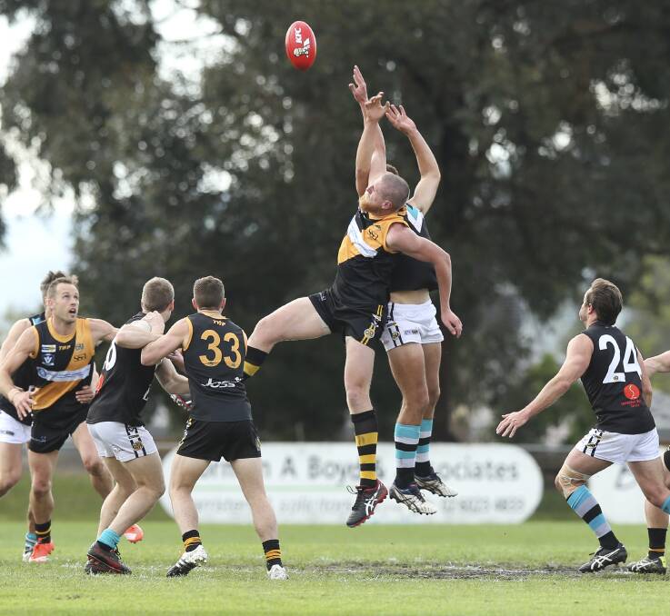 BIG MEN FLY: Albury ruckman Ben Dower wins the hitout against Lavington's Tom Yensch in Saturday's second semi-final at Birallee Park. Dower was among the Tigers' better players. Pictures: ELENOR TEDENBORG