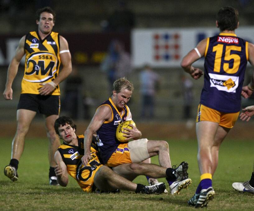 Ovens and Murray star Joel Mackie tackles Brad Murray, when he was in the Goulburn Valley, during an interleague clash in 2010.
