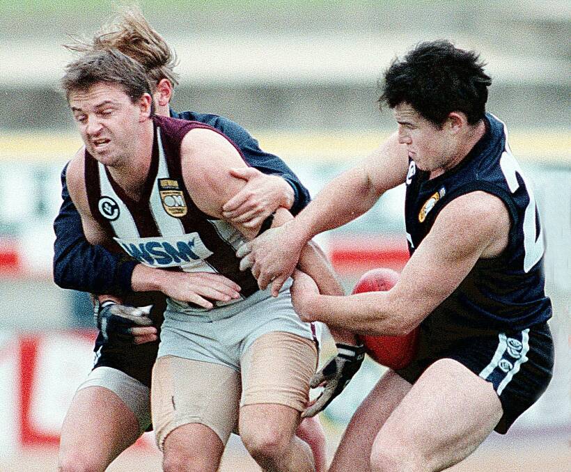 HARDS' LUCK STORY: Dean Harding is tackled by Lavington's Nick Carroll in 1998. Harding joined Wodonga in 1994 and, apart from a season coaching Rutherglen in 2004, hasn't left the Ovens and Murray club since.