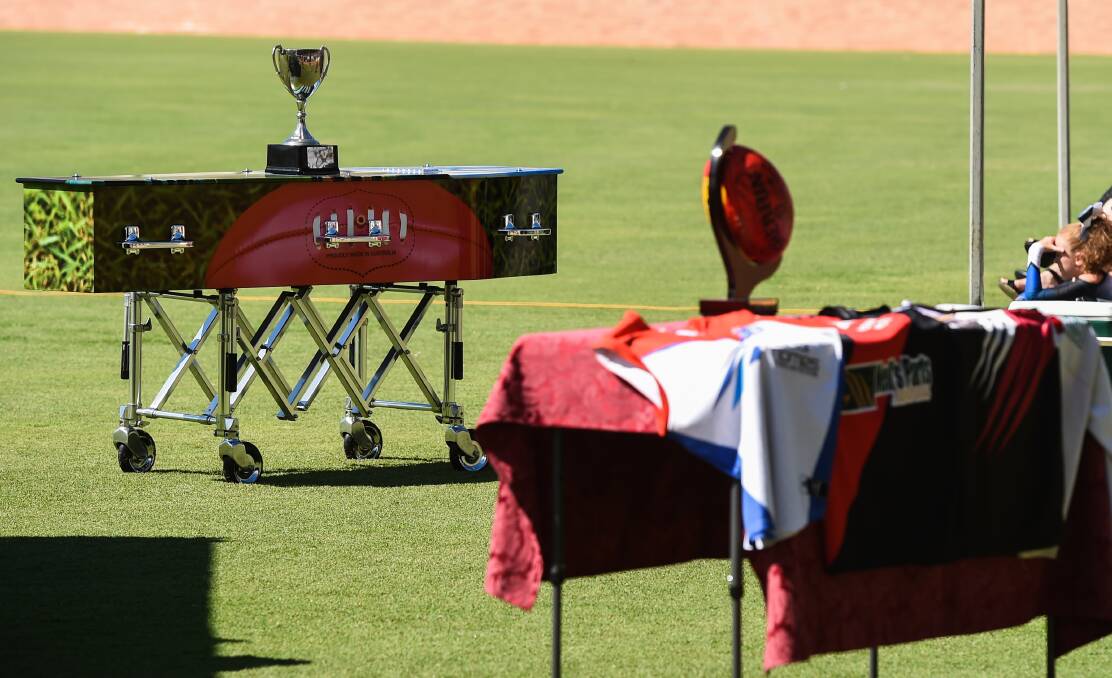 KEEPSAKES: There was a strong football theme to Karl Jacka's funeral with Balranald's premiership cup and some of his former jumpers on display.