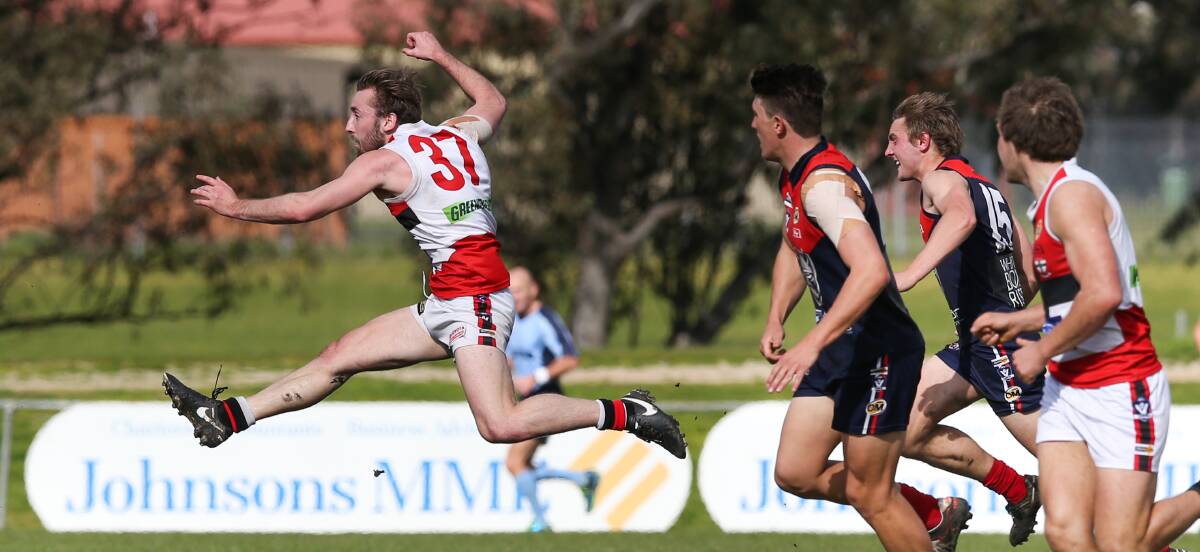 FULL FLIGHT: Elijah Wales pumps Myrtleford into attack in the Saints' first victory at Birallee Park since 2007. Jarrod Hayse sealed the win with a kick after the siren.